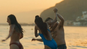 Asha Banks beach bikini scene running and playing in water at sunset My Fault London 2025, golden natural light, summery romantic vibe.