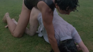 A man in black underwear fucked with Aki Hayasaka wearing a light-colored shirt on a green lawn.