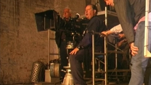 Topless Anna Galiena in full frontal view from Black Angel (2002), breasts exposed in sex scene with older shirtless man from behind. - img #13