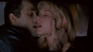 Close-up intimate moment between Patrick Swayze and Deborah Kara Unger in Crash (1996), face-to-face embrace with dramatic lighting on faces, 1990s film aesthetic