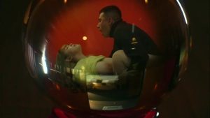 screenshot from the 2020 adult game Fight the Dragon: Big Breasts, Game of Death, featuring an intimate encounter viewed through a distorted spherical lens.