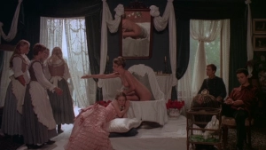 Private Vices Public Pleasures 1976 - Bedroom scene with a nude figure sitting on a bed as three maids stand nearby and a woman rests on the floor.