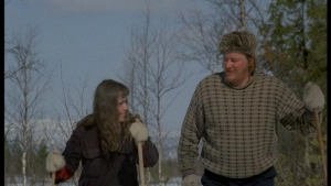 Maritta Viitamäki and a man lying in hay in The Earth Is a Sinful Song (1973).