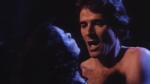 Intimate close-up shot of Richard Gere and Kamala Lopez - dark, moody scene from Erotique (1994) segment 1.