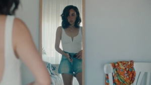 Katia Borlado in a bedroom, scene from Notes on a Summer (2023)