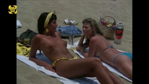 Monique Lafond nude in I (1987) with Monique Evans on a beach